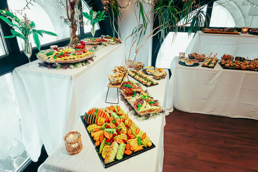 Elegant indoor buffet with diverse cuisines, vibrant decor, and fresh plant arrangements.